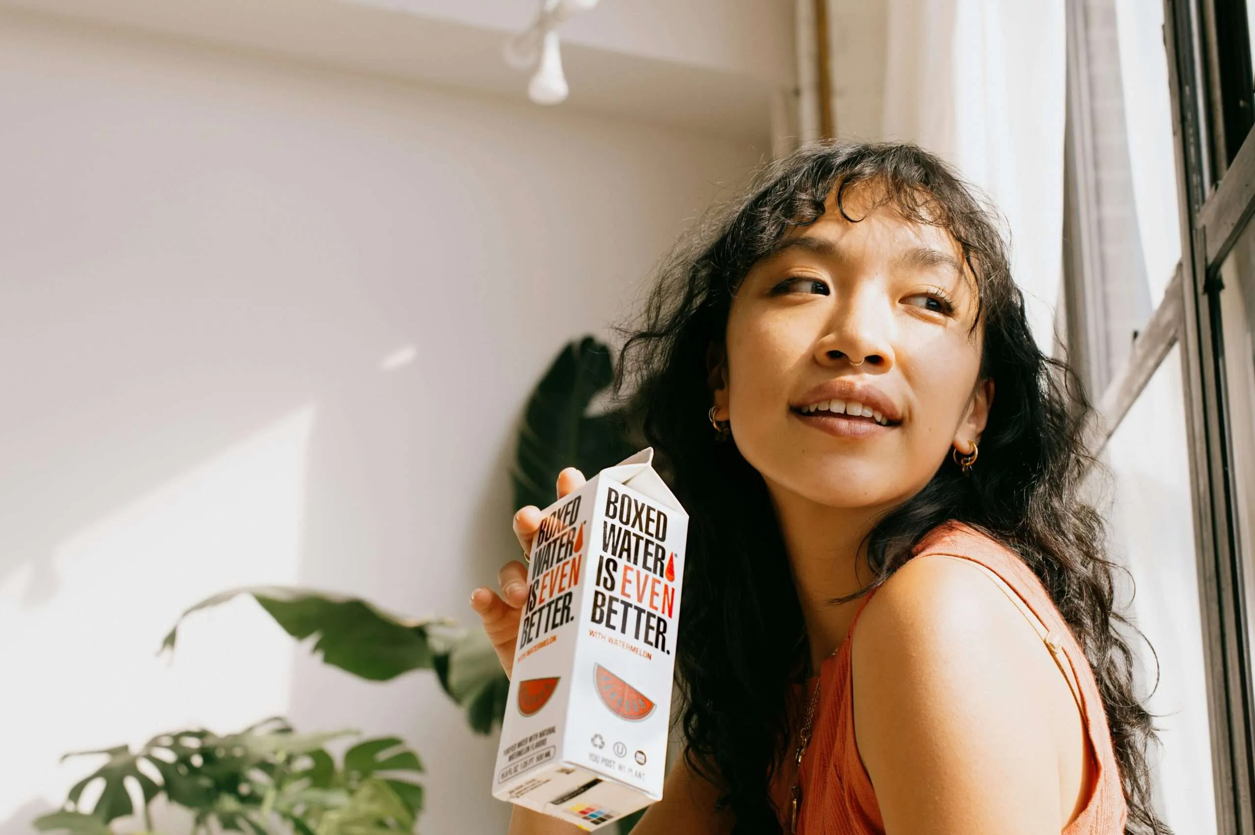 Home a woman holding up a carton of milk