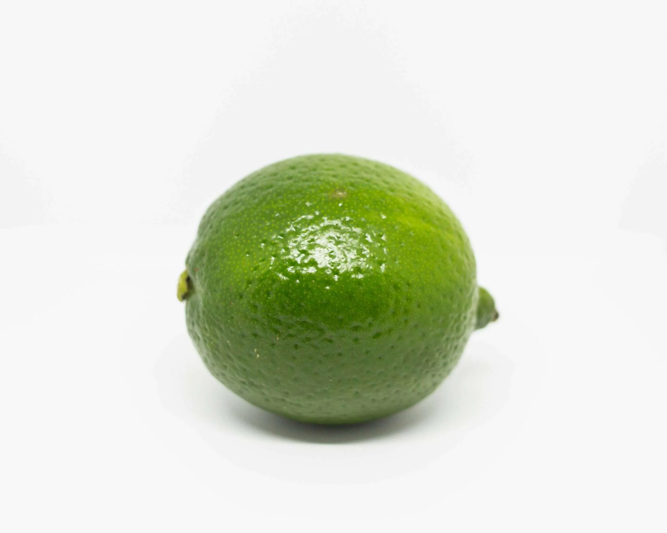 Home green lime fruit on white surface