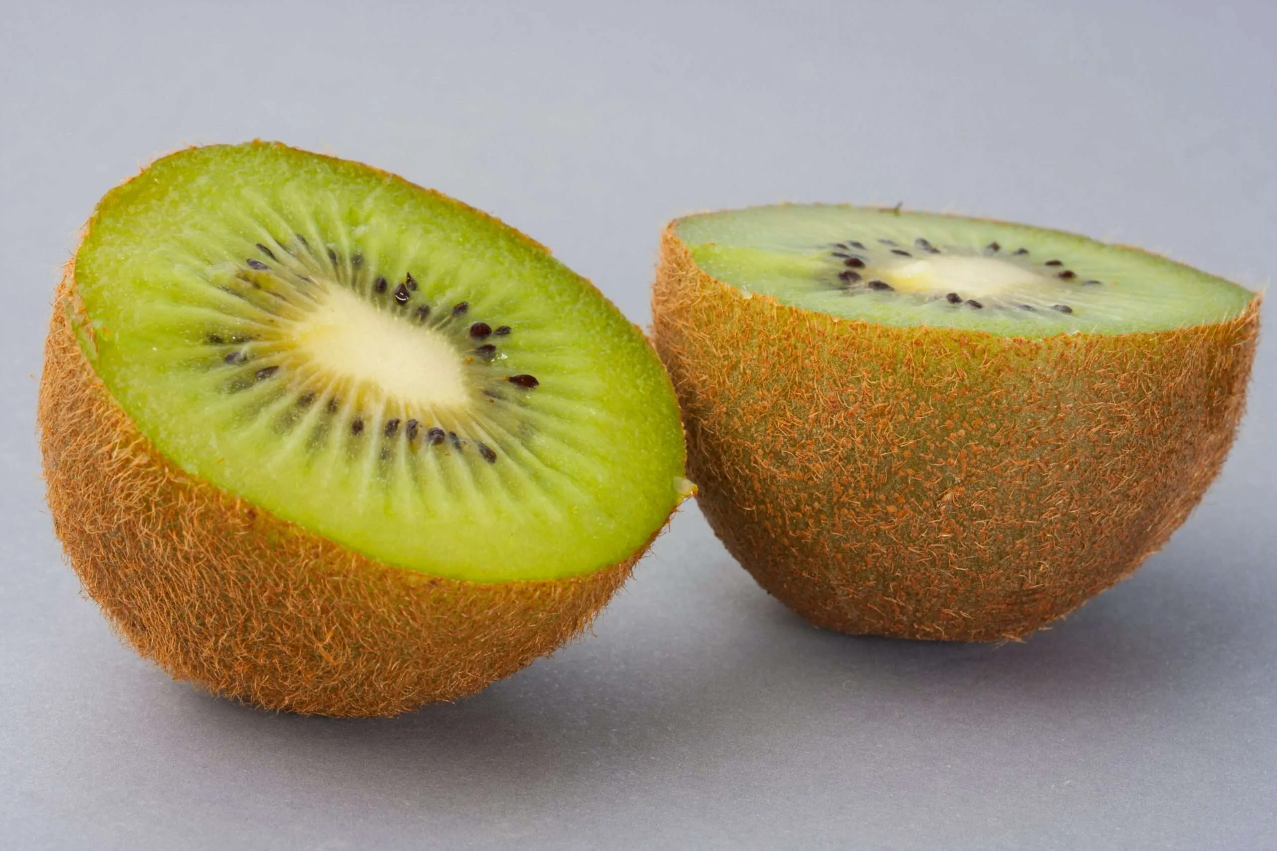 Home sliced green fruit on white surface