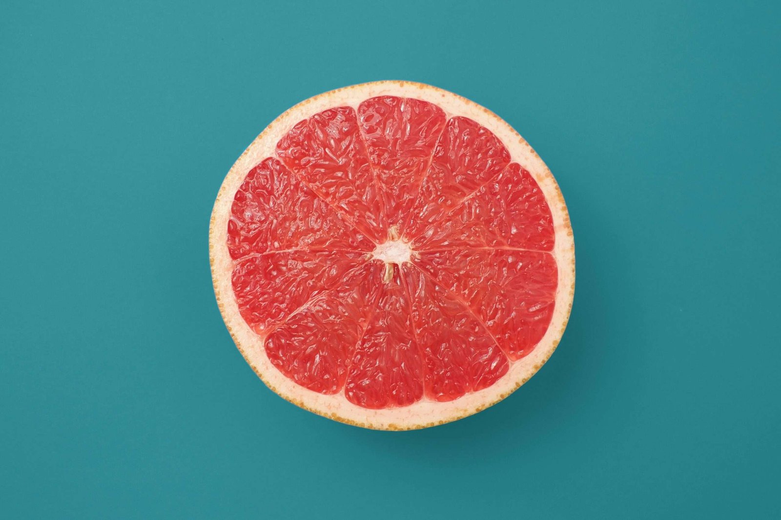 Home sliced orange fruit on blue background